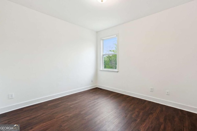 2539 Larson Creek Cv, Duluth, GA 30097 - spare room featuring baseboards and dark wood-style floors