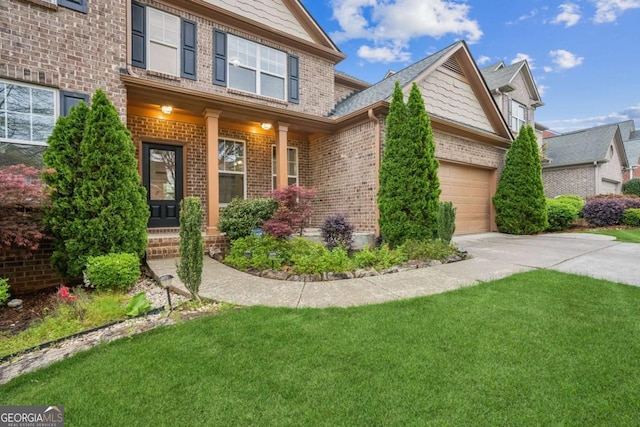 2539 Larson Creek Cv, Duluth, GA 30097 - craftsman-style house with brick siding, a garage, concrete driveway, and a front yard