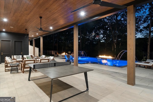 4451 Shellie Ln, Oakwood, GA 30566 - patio at night featuring ceiling fan, a patio area, and a fire pit