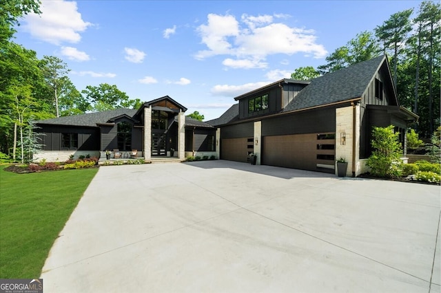 4451 Shellie Ln, Oakwood, GA 30566 - modern home with driveway, a front yard, a shingled roof, board and batten siding, and an attached garage