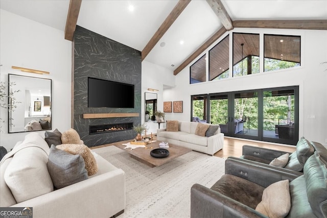 4451 Shellie Ln, Oakwood, GA 30566 - living area with high vaulted ceiling, a fireplace, beamed ceiling, and wood finished floors