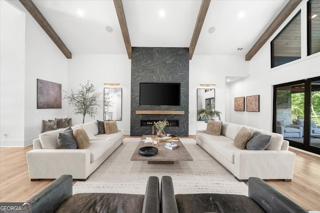 4451 Shellie Ln, Oakwood, GA 30566 - living area featuring wood finished floors, beam ceiling, and a premium fireplace