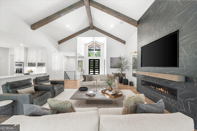 4451 Shellie Ln, Oakwood, GA 30566 - living area featuring wood finished floors, a large fireplace, beam ceiling, high vaulted ceiling, and recessed lighting