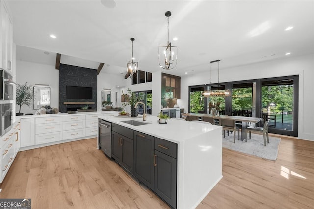 4451 Shellie Ln, Oakwood, GA 30566 - kitchen with white cabinets, appliances with stainless steel finishes, open floor plan, a chandelier, and light countertops