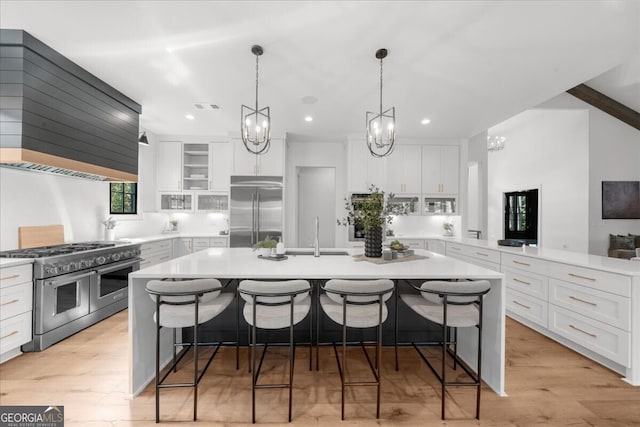 4451 Shellie Ln, Oakwood, GA 30566 - kitchen featuring high quality appliances, range hood, a center island with sink, light countertops, and recessed lighting
