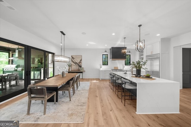 4451 Shellie Ln, Oakwood, GA 30566 - dining area featuring a chandelier, light wood-type flooring, healthy amount of natural light, recessed lighting, and french doors