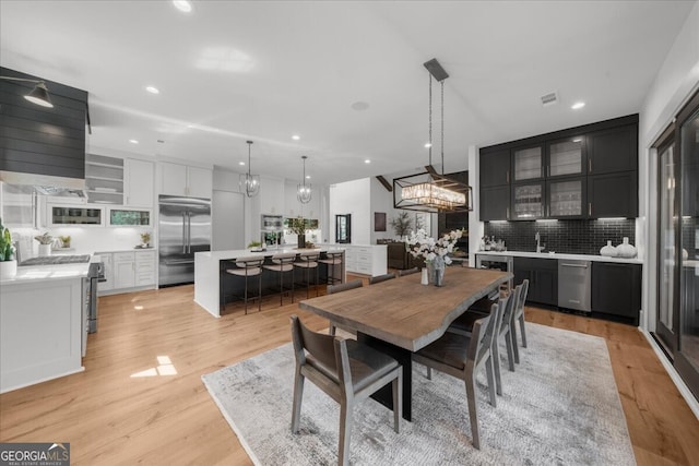 4451 Shellie Ln, Oakwood, GA 30566 - dining space featuring light wood-style floors, recessed lighting, a chandelier, and beverage cooler