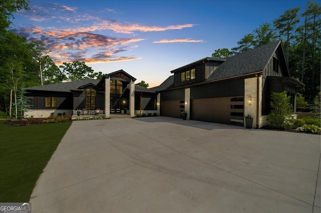 4451 Shellie Ln, Oakwood, GA 30566 - contemporary home with concrete driveway, board and batten siding, a garage, a yard, and roof with shingles