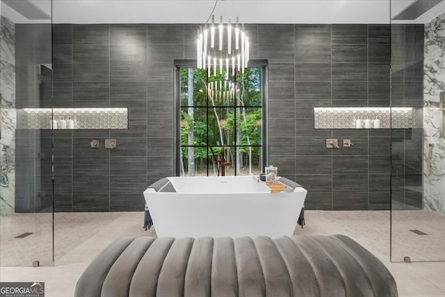 4451 Shellie Ln, Oakwood, GA 30566 - bathroom featuring tile walls, a freestanding tub, a chandelier, and walk in shower
