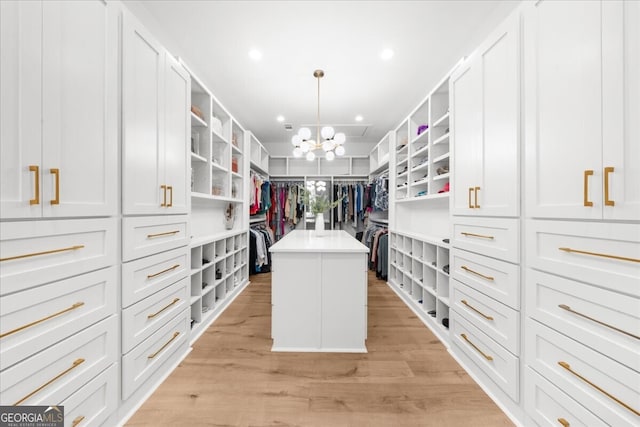 4451 Shellie Ln, Oakwood, GA 30566 - spacious closet featuring a chandelier and light wood-style flooring