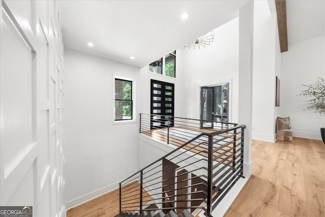 4451 Shellie Ln, Oakwood, GA 30566 - corridor with an upstairs landing, wood finished floors, recessed lighting, and a high ceiling