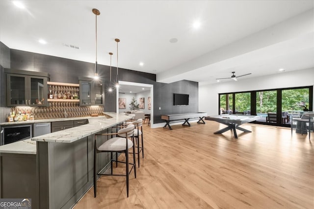 4451 Shellie Ln, Oakwood, GA 30566 - kitchen featuring open floor plan, light wood-style floors, light stone countertops, tasteful backsplash, and recessed lighting