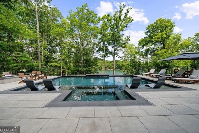 4451 Shellie Ln, Oakwood, GA 30566 - view of swimming pool featuring a patio, a pool with connected hot tub, and view of scattered trees