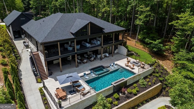 4451 Shellie Ln, Oakwood, GA 30566 - back of property featuring an outdoor living space, outdoor dining area, roof with shingles, and a fenced backyard