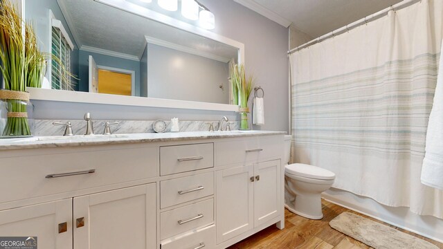 241 Lavern Ct, Winder, GA 30680 - full bathroom featuring wood finished floors, crown molding, and double vanity