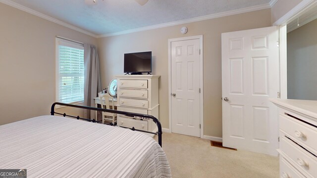 241 Lavern Ct, Winder, GA 30680 - bedroom with ornamental molding, light carpet, and a ceiling fan