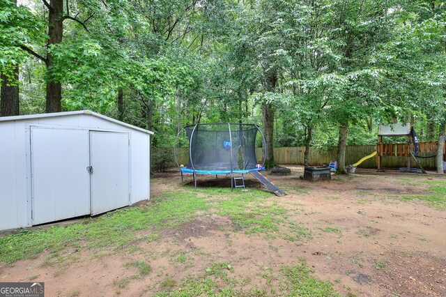 241 Lavern Ct, Winder, GA 30680 - view of yard with a trampoline, a storage shed, and a playground