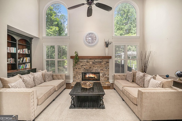 1155 Admiral Xing, Alpharetta, GA 30005 - living room featuring a towering ceiling, ceiling fan, a fireplace, and wood finished floors