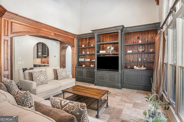 1155 Admiral Xing, Alpharetta, GA 30005 - living area featuring a high ceiling, stone tile flooring, and arched walkways