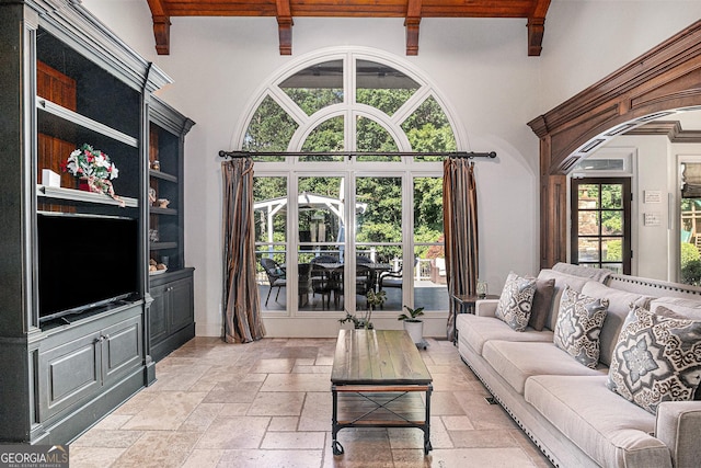 1155 Admiral Xing, Alpharetta, GA 30005 - living area featuring stone tile floors, beam ceiling, and a towering ceiling
