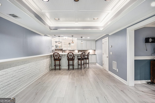 1155 Admiral Xing, Alpharetta, GA 30005 - kitchen with a kitchen breakfast bar, light wood-style flooring, white cabinets, hanging light fixtures, and crown molding