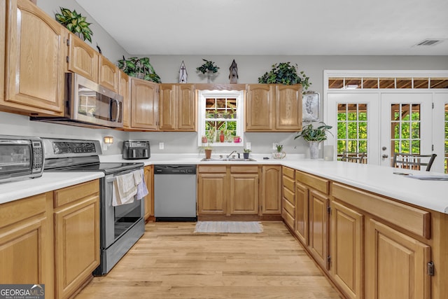 15 Bern Vis, Sautee Nacoochee, GA 30571 - kitchen with stainless steel appliances, light wood-style flooring, healthy amount of natural light, and light countertops