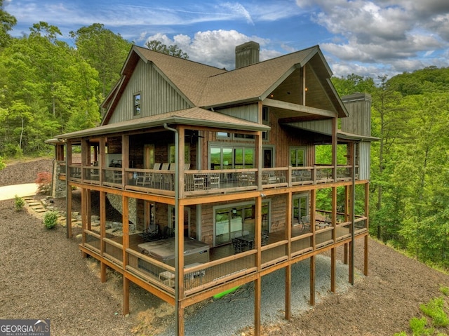 330 Serenity Ridge Ln, Mineral Bluff, GA 30559 - back of property with a chimney, a shingled roof, a deck, and a wooded view