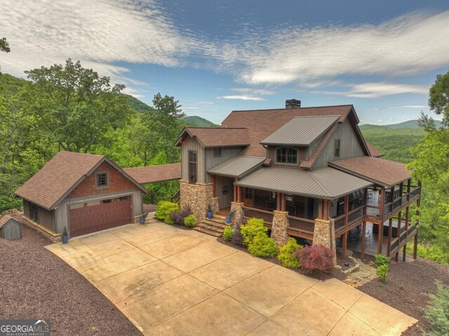 330 Serenity Ridge Ln, Mineral Bluff, GA 30559 - view of front of home featuring an outdoor structure, stone siding, driveway, a metal roof, and a porch