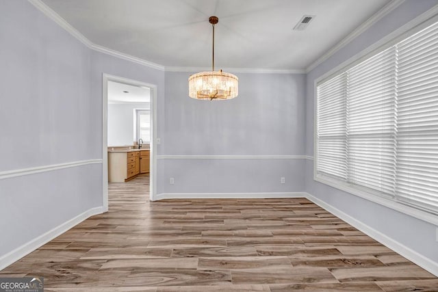269 Legends Trce, Mcdonough, GA 30253 - unfurnished dining area featuring light wood-style floors, a chandelier, and ornamental molding