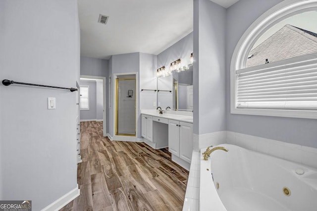 269 Legends Trce, Mcdonough, GA 30253 - full bathroom featuring vanity, a shower stall, a whirlpool tub, and wood finished floors