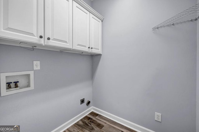 269 Legends Trce, Mcdonough, GA 30253 - laundry area with electric dryer hookup, cabinet space, dark wood-style floors, and washer hookup