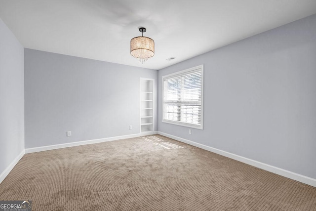 269 Legends Trce, Mcdonough, GA 30253 - carpeted empty room featuring built in shelves and baseboards