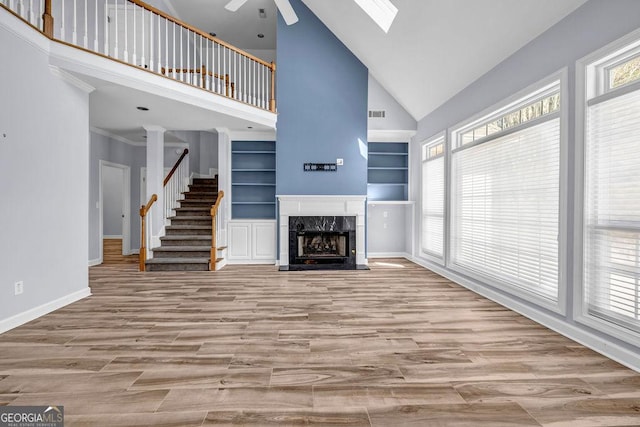 269 Legends Trce, Mcdonough, GA 30253 - unfurnished living room with high vaulted ceiling, ceiling fan, wood finished floors, stairway, and a premium fireplace