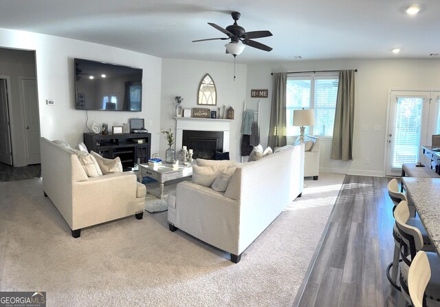 5257 Shorthorn Way, Powder Springs, GA 30127 - living room featuring a fireplace, a ceiling fan, wood finished floors, carpet floors, and recessed lighting