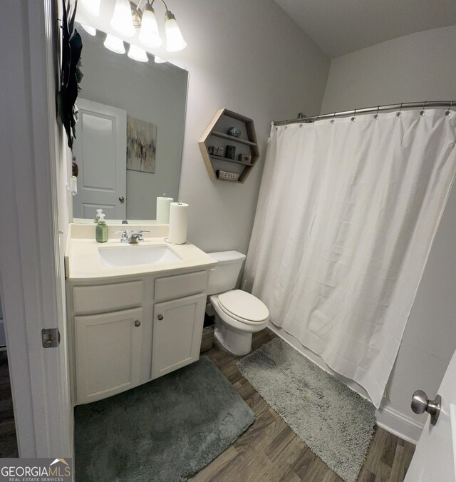 5257 Shorthorn Way, Powder Springs, GA 30127 - full bathroom with wood finished floors, vanity, a chandelier, and a shower with shower curtain