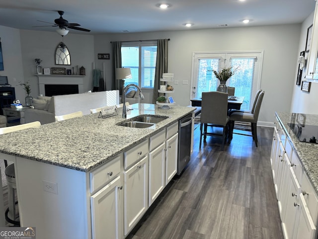 5257 Shorthorn Way, Powder Springs, GA 30127 - kitchen featuring stainless steel dishwasher, a ceiling fan, white cabinets, a fireplace, and light stone countertops