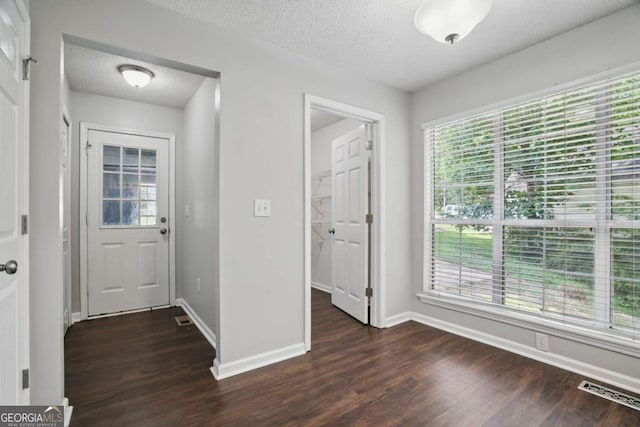 46 Highland Ct, Carrollton, GA 30116 - foyer entrance featuring dark wood-style flooring and a textured ceiling