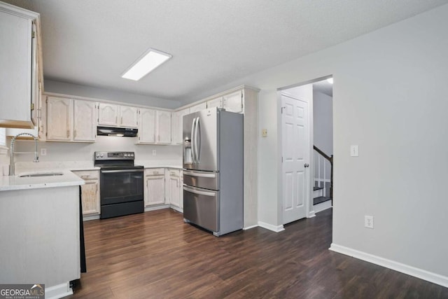 46 Highland Ct, Carrollton, GA 30116 - kitchen featuring range with electric stovetop, stainless steel refrigerator with ice dispenser, under cabinet range hood, light countertops, and dark wood-type flooring