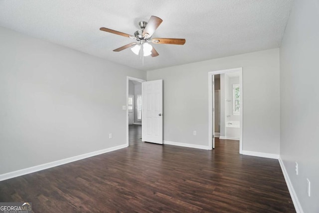 46 Highland Ct, Carrollton, GA 30116 - unfurnished bedroom featuring dark wood-type flooring, multiple windows, a textured ceiling, and ceiling fan