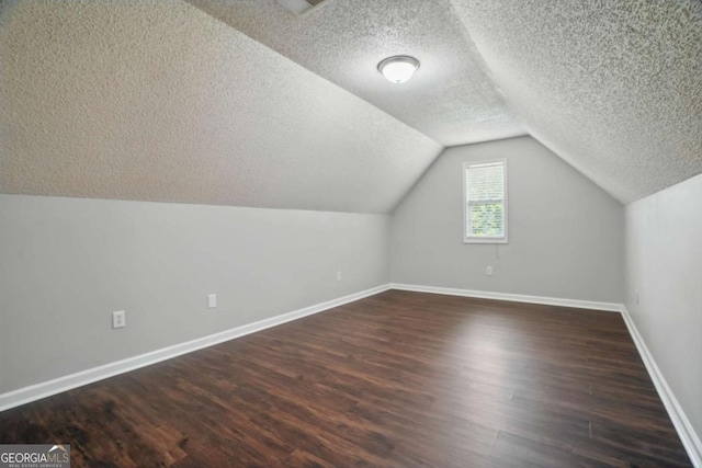 46 Highland Ct, Carrollton, GA 30116 - additional living space featuring dark wood-type flooring, a textured ceiling, and lofted ceiling