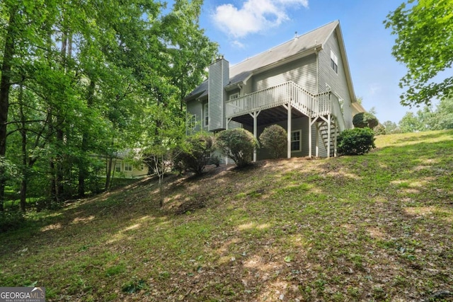 46 Highland Ct, Carrollton, GA 30116 - rear view of property featuring a deck and a chimney