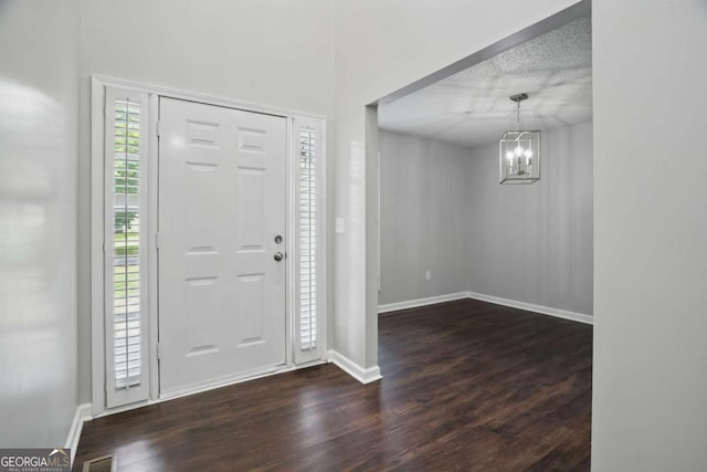46 Highland Ct, Carrollton, GA 30116 - foyer entrance featuring dark wood-style flooring and a chandelier