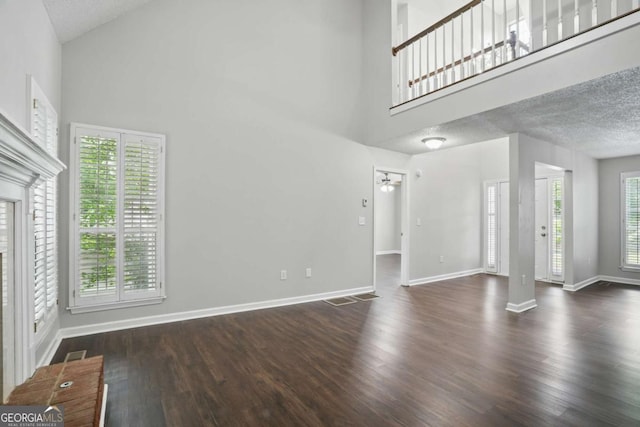 46 Highland Ct, Carrollton, GA 30116 - unfurnished living room with high vaulted ceiling, wood finished floors, and a textured ceiling