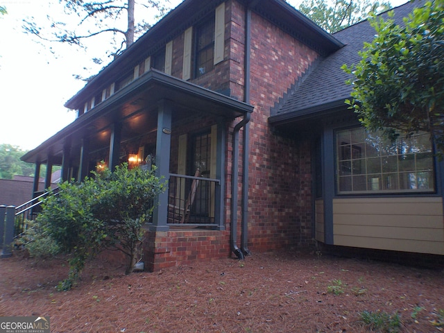 5741 Wolf Laurel Ln SW, Lilburn, GA 30047 - view of side of home featuring brick siding and a porch