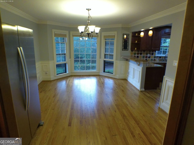5741 Wolf Laurel Ln SW, Lilburn, GA 30047 - kitchen with freestanding refrigerator, a chandelier, a decorative wall, light wood finished floors, and open shelves