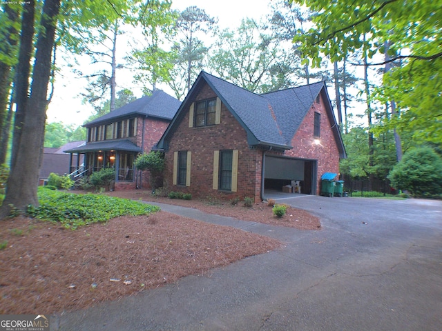 5741 Wolf Laurel Ln SW, Lilburn, GA 30047 - view of front of house featuring brick siding, driveway, and a shingled roof