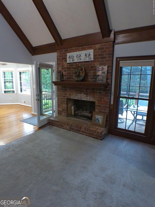 5741 Wolf Laurel Ln SW, Lilburn, GA 30047 - unfurnished living room featuring a brick fireplace, plenty of natural light, and carpet floors