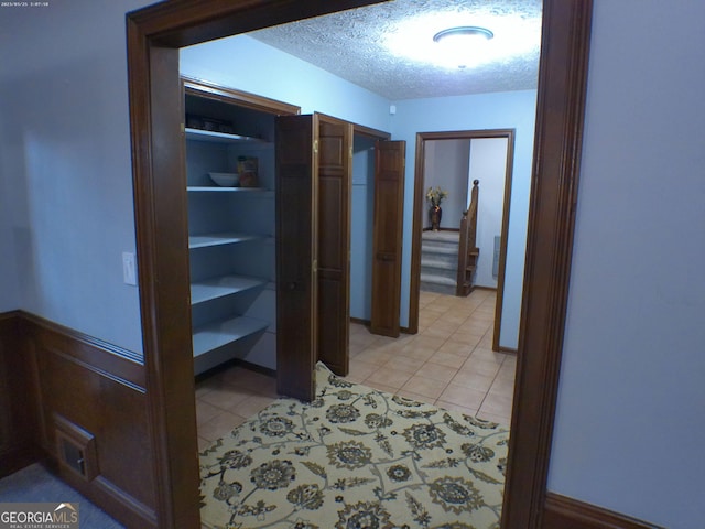 5741 Wolf Laurel Ln SW, Lilburn, GA 30047 - corridor featuring light tile patterned floors and a textured ceiling