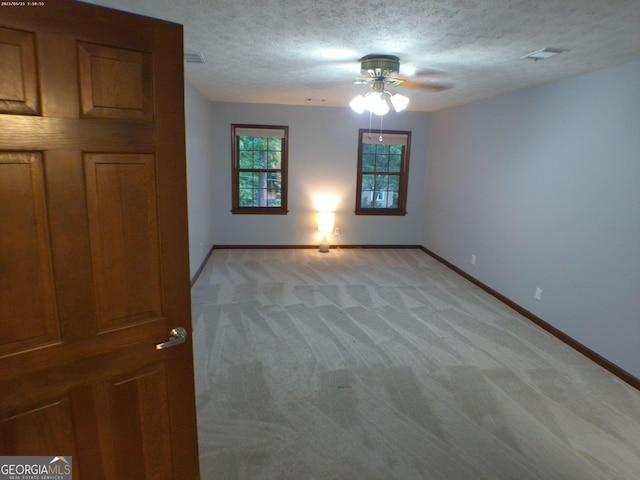 5741 Wolf Laurel Ln SW, Lilburn, GA 30047 - spare room with ceiling fan, light colored carpet, and a textured ceiling