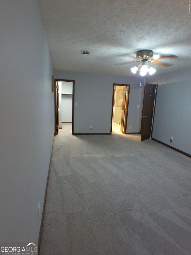 5741 Wolf Laurel Ln SW, Lilburn, GA 30047 - spare room with ceiling fan, light carpet, and a textured ceiling